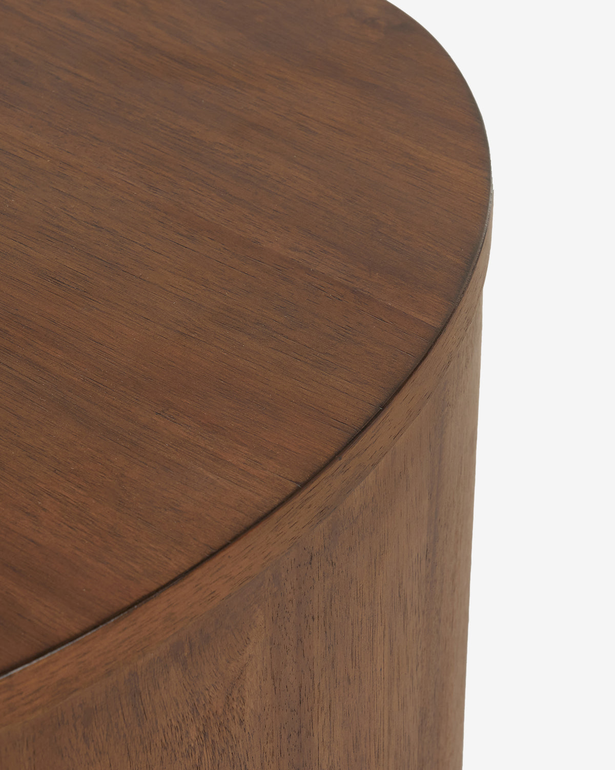 Close-up of the top and side of the Steffon Nightstand, a round acacia wood table with a smooth medium-brown finish—ideal for elegant bedroom decor—shown against a plain white background by McGee & Co.