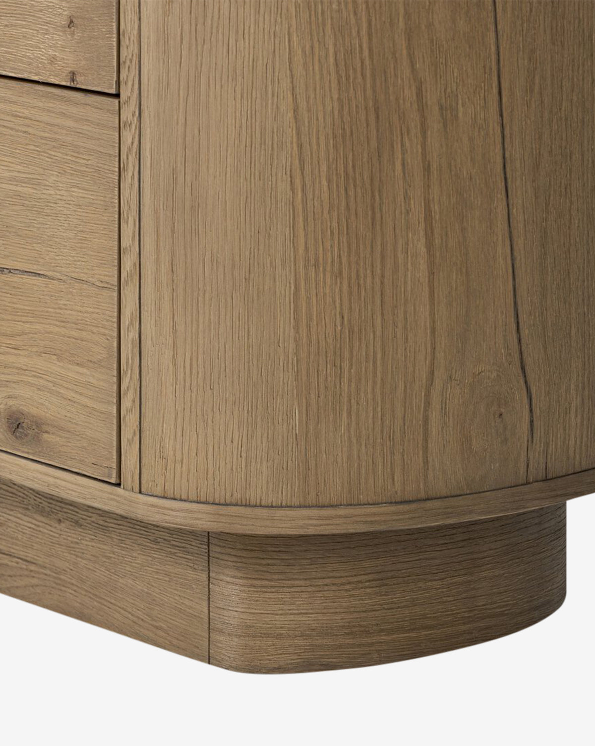 Close-up of the Steffon Nightstand’s bottom corner, showcasing its acacia wood build, natural light brown finish, visible wood grain, and smooth curved edges—ideal for adding elegance to your bedroom décor, by McGee & Co.