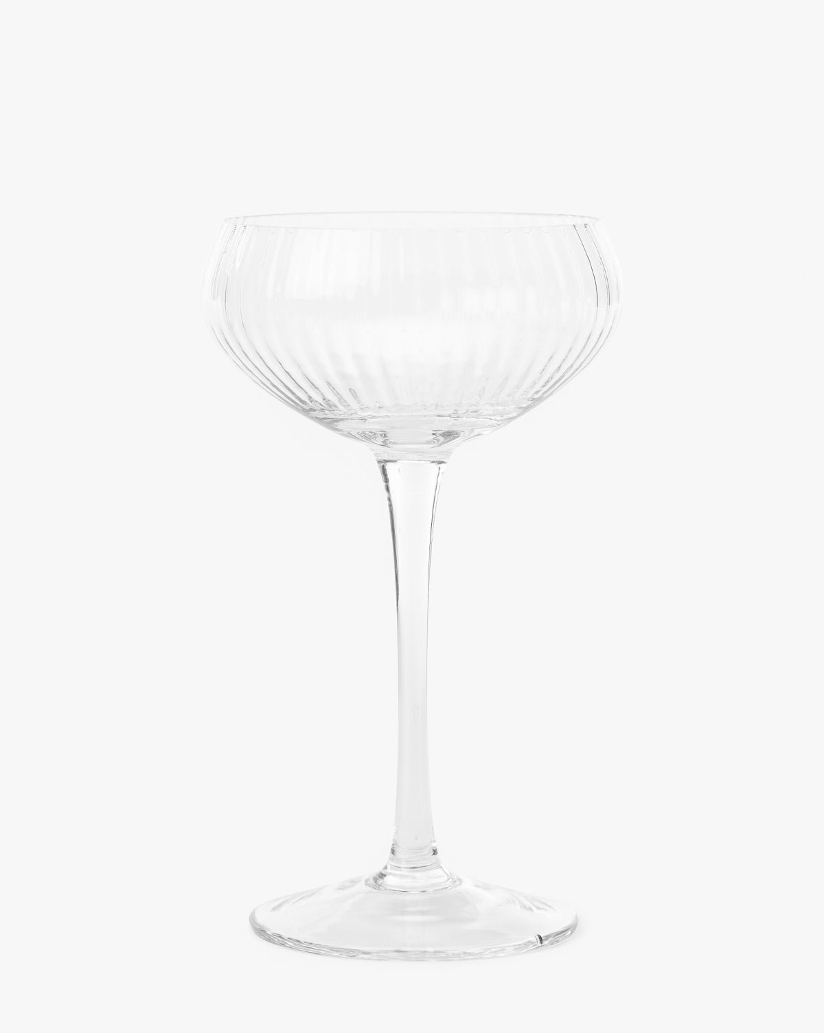 The Stemmed Champagne Glass features a clear, ribbed design with a wide bowl and long stem, embodying elegant glassware against a plain white background, by McGee & Co.