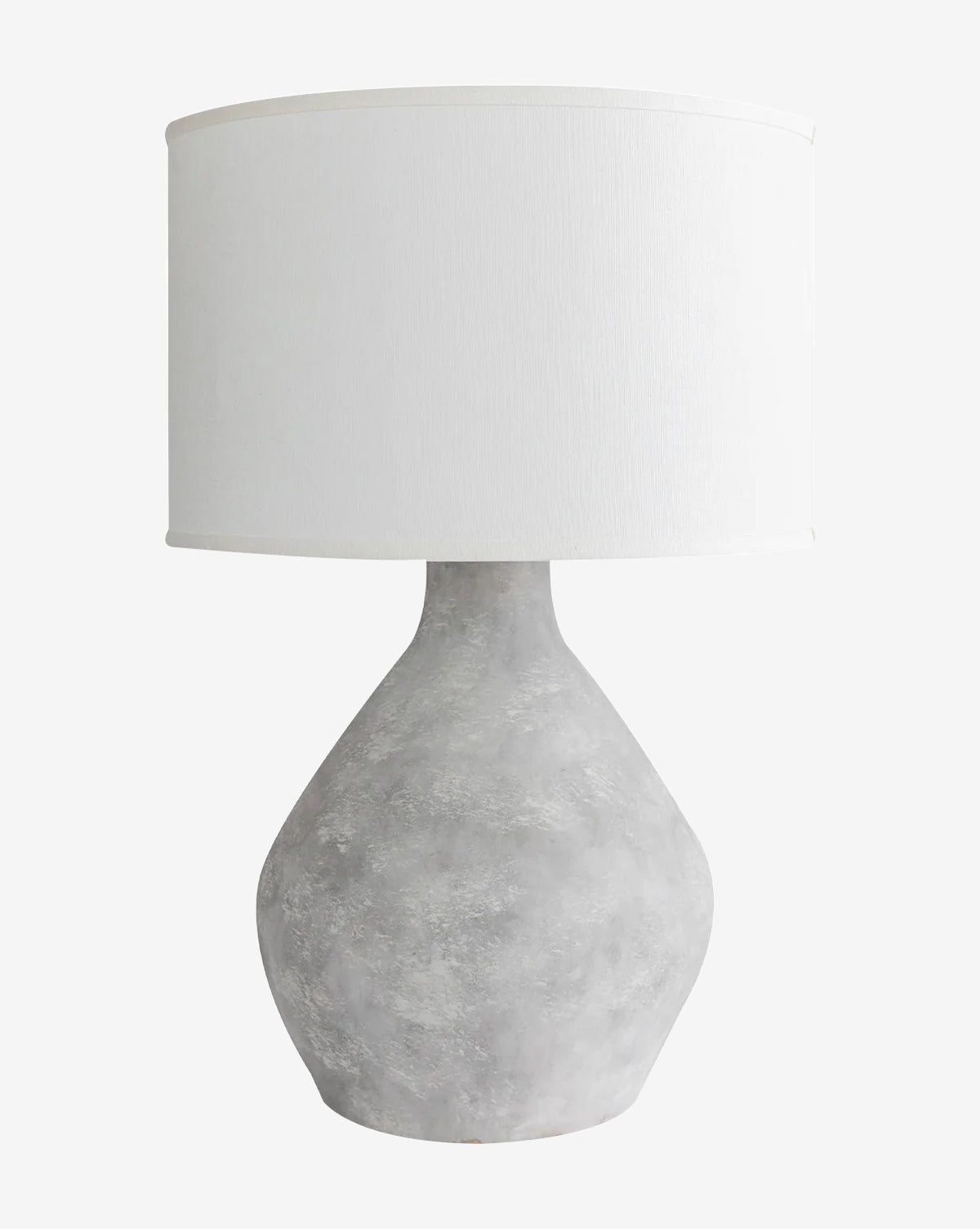 The Stetson Table Lamp by Troy Lighting features a textured gray ceramic base and a large fabric drum shade, making it an ideal minimalist lamp for modern spaces. McGee & Co.