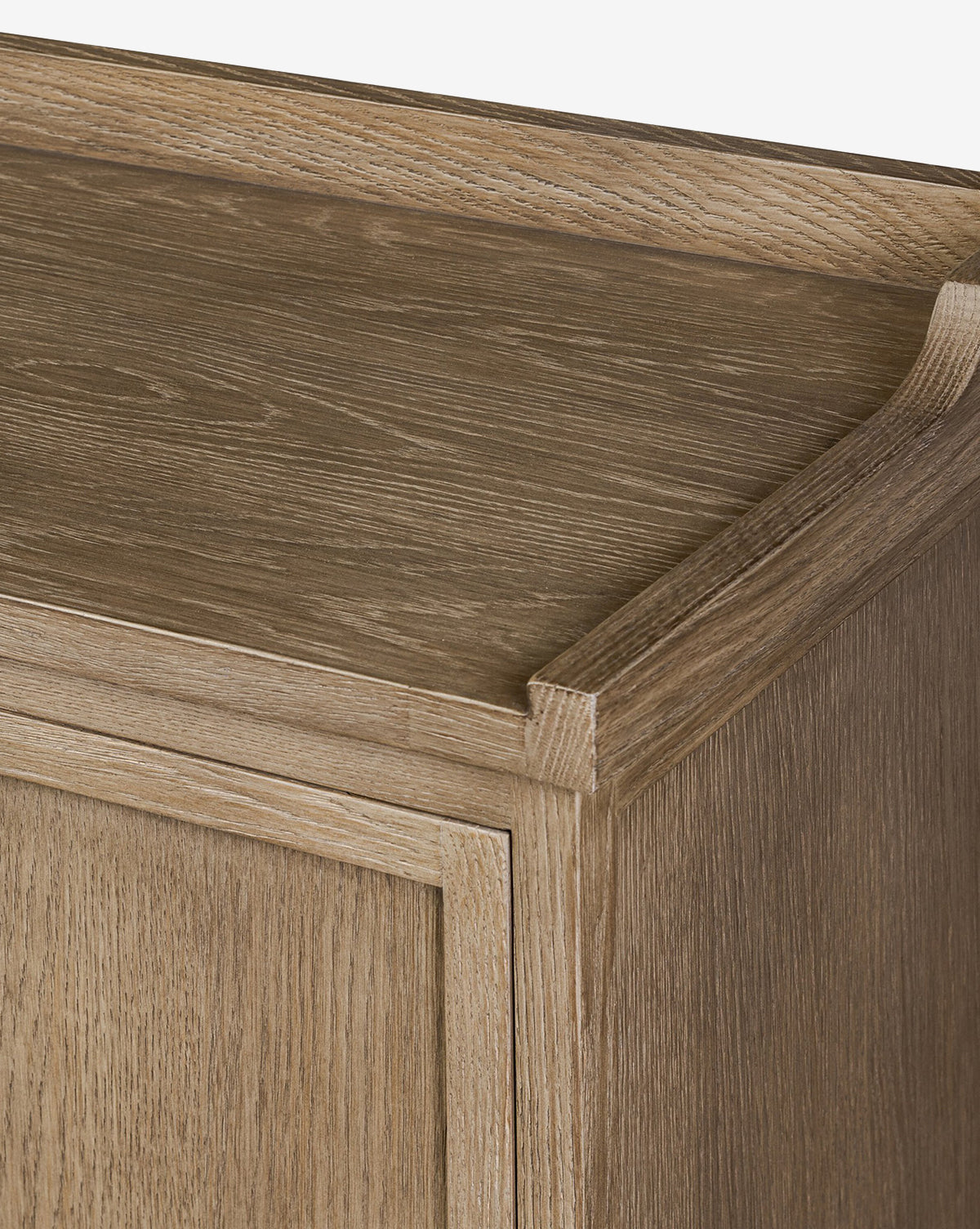 Close-up of the Stonington Oak Sideboards top corner featuring a light brown, weathered oak finish with visible wood grain and a raised edge detail along the back and side, by McGee & Co.