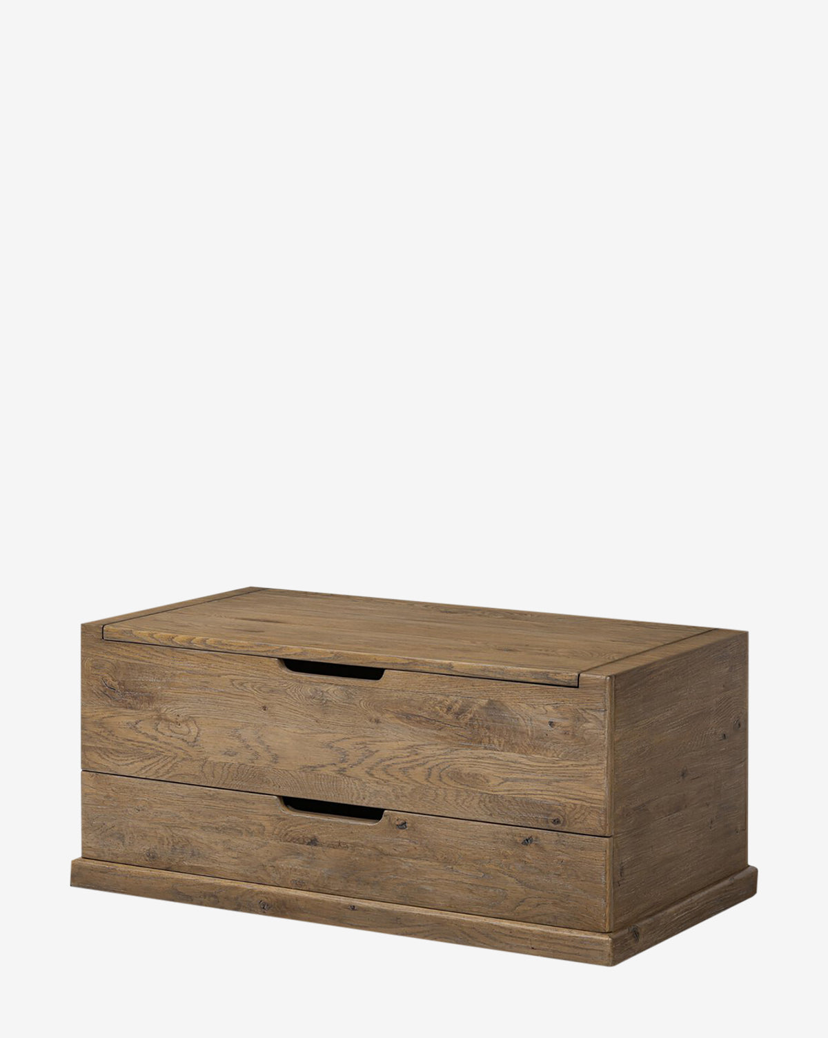 The Sutton Trunk is a rectangular storage chest with a hinged lid, two pull-out drawers, and a weathered oak finish highlighting its natural wood grain and minimalist design, by McGee & Co.
