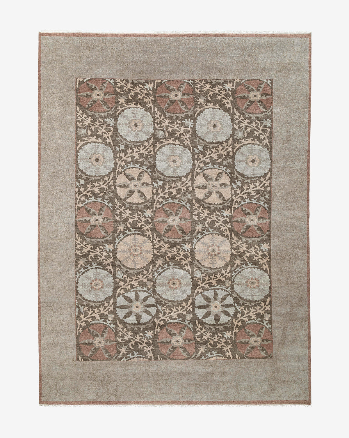 The Suzani Hand-Knotted Wool Rug is rectangular and features a muted border with repeating floral and geometric medallions in earthy brown, beige, blue, and cream tones, by McGee & Co.