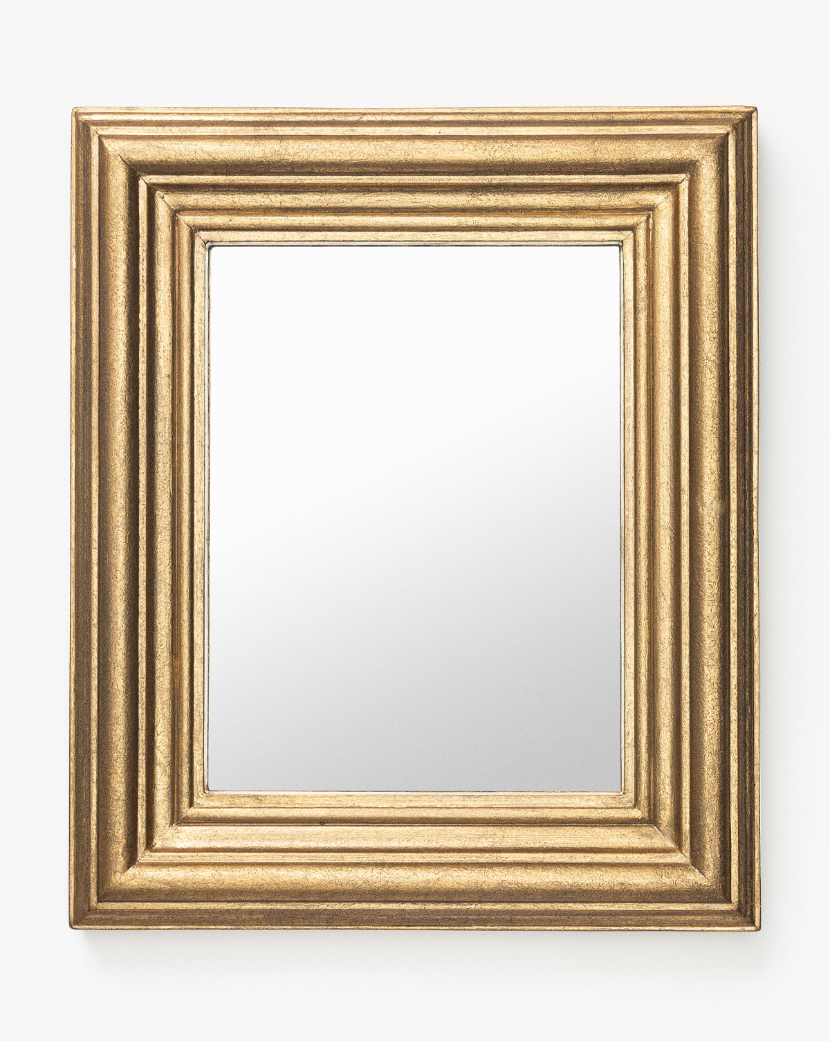 The Suzanne Shelf Mirror features a wide gold-finished rectangular frame with elegant ridged detailing, displayed against a plain white background by McGee & Co.