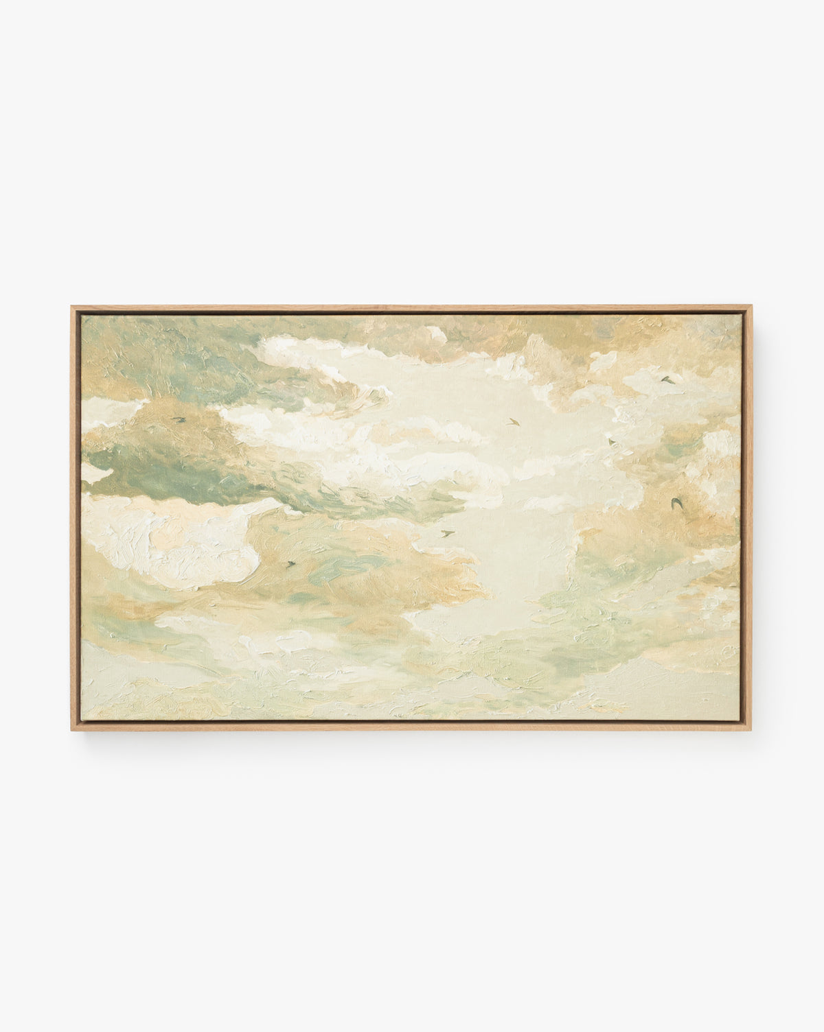 The Swallows at Dusk framed wall art features a soft, abstract sky scene in cream, beige, and green tones that evoke clouds and gentle sunlight. It’s finished with a sleek white oak frame for a modern look, by McGee & Co.