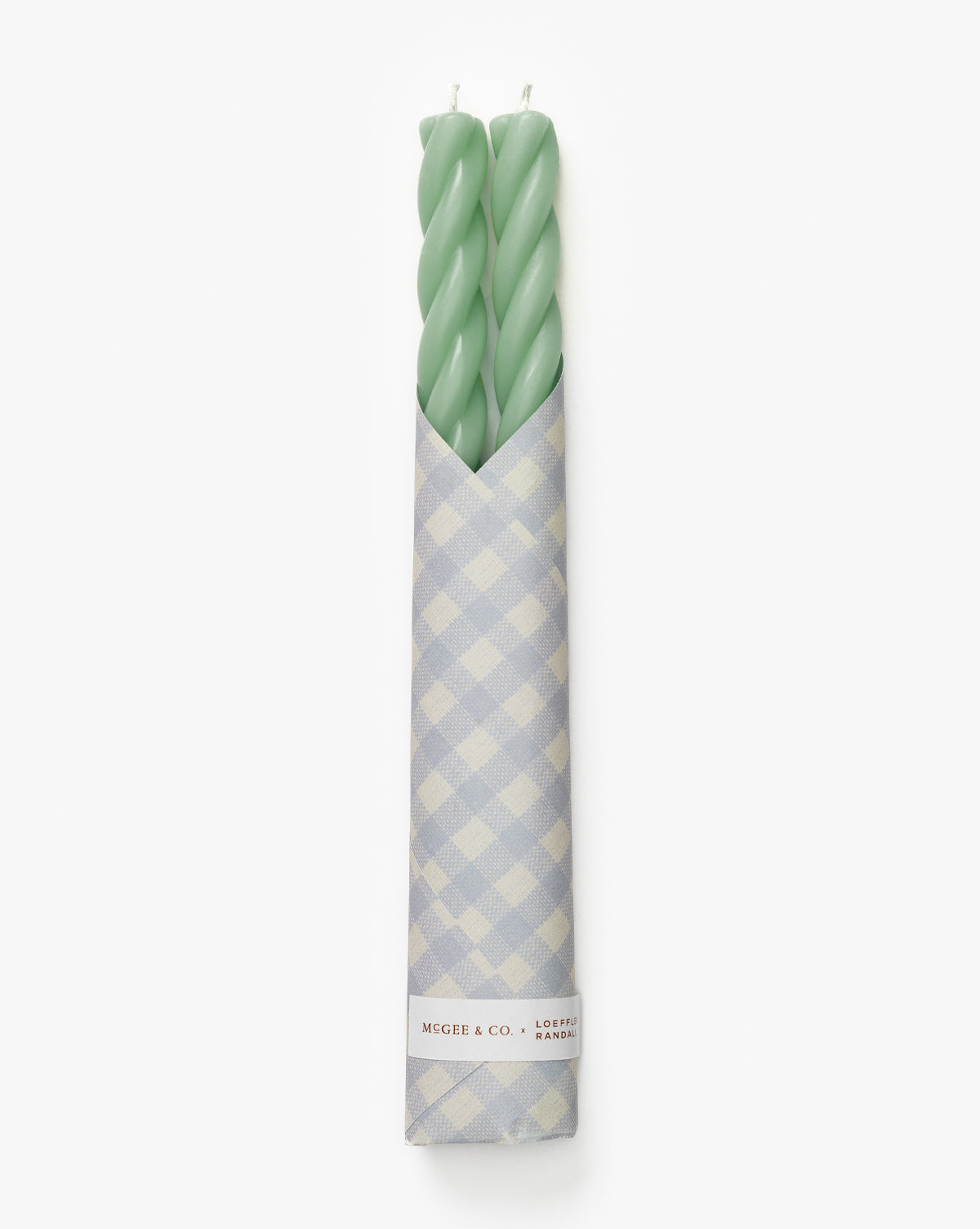 The McGee & Co. x Loeffler Randall Sybil Wax Taper Candles (Set of 2) in light green, wrapped in blue and white gingham paper, add a charming designer touch to your decor, by McGee & Co.
