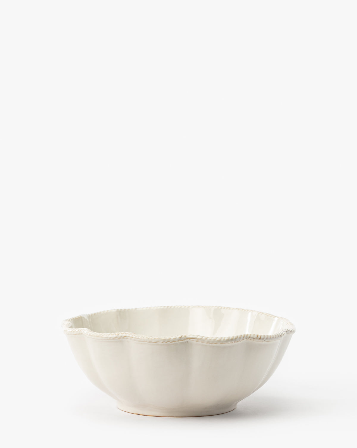 The McGee & Co. x Loeffler Randall Tabitha Serving Bowl features a white ceramic design with a scalloped edge and subtle decorative rim, shown against a plain white background, by McGee & Co.