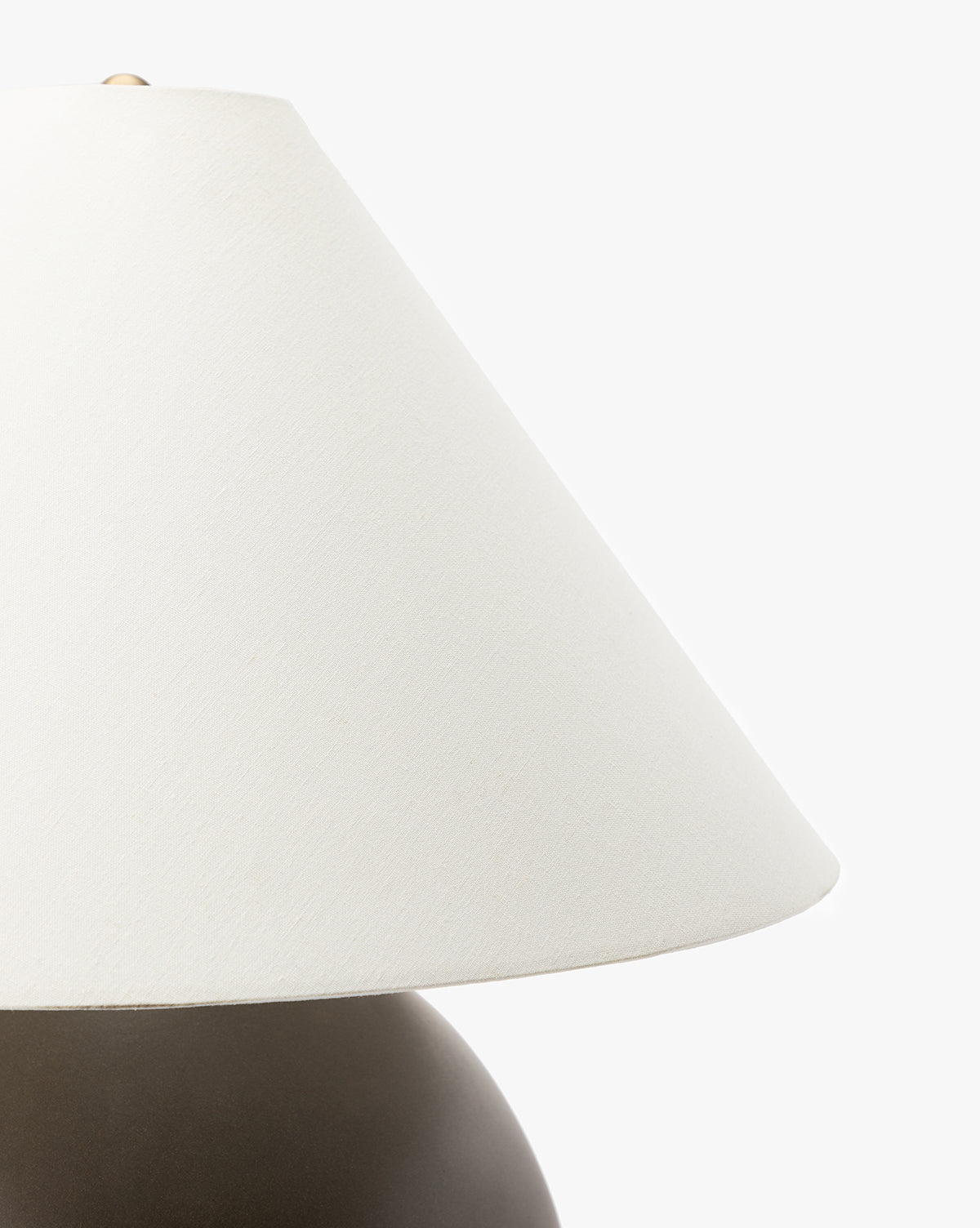 Close-up of the Tess Large Ceramic Table Lamp featuring a white, conical lampshade and a round, dark brown base, set against a plain white background by McGee & Co.