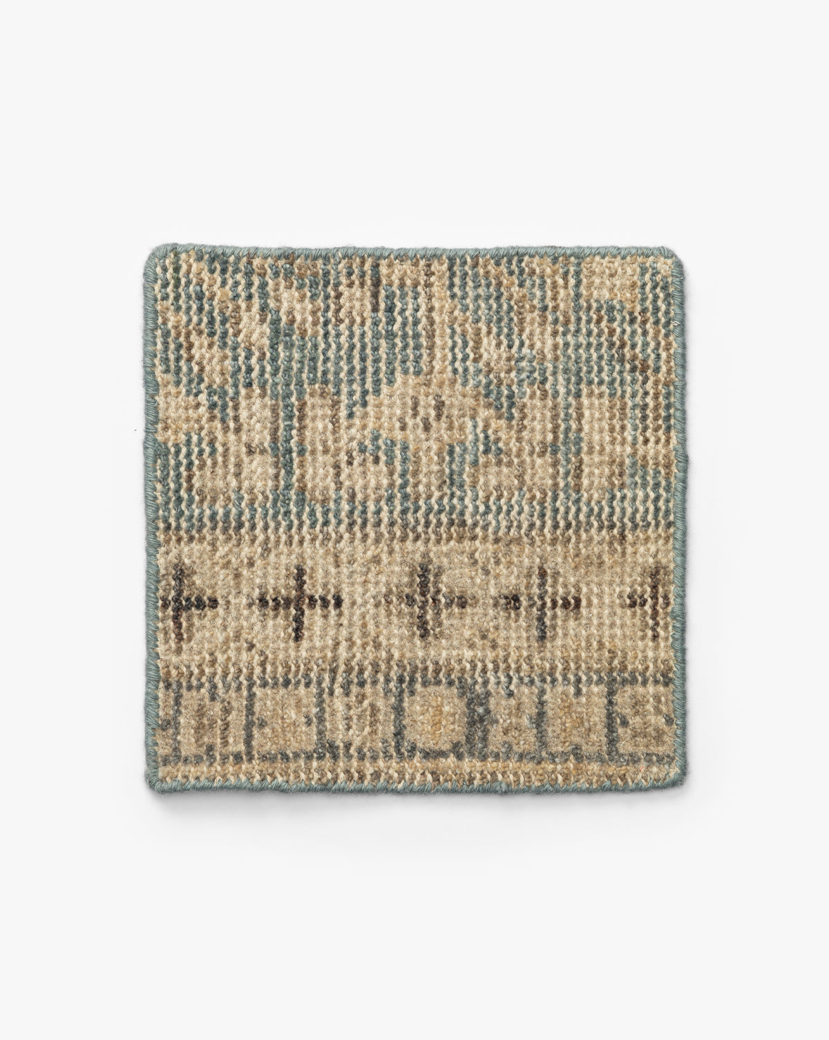 The Thames Hand-Knotted Rug Swatch is a small, rectangular sample featuring a beige, tan, and light blue geometric pattern with triangles, crosses, and a blue border—ideal for adding a touch of luxury or antique-inspired style to your home, by McGee & Co.