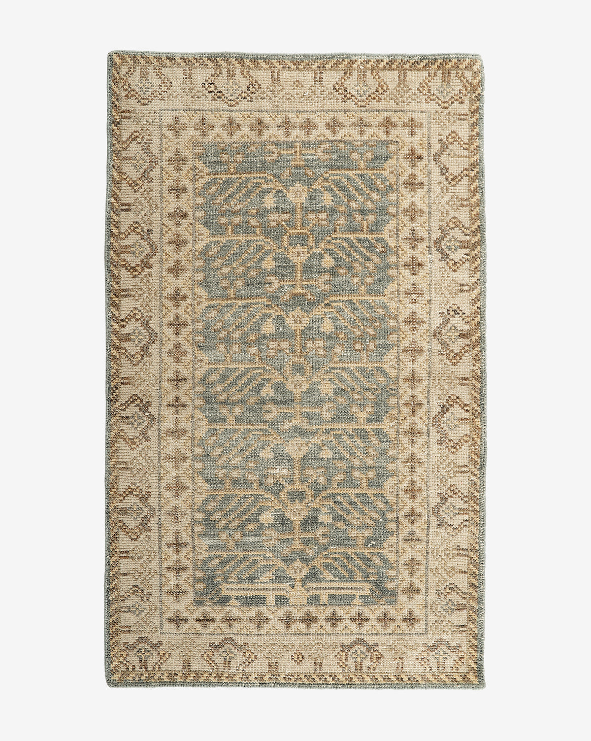 The Thames Hand-Knotted Rug features an ornate central motif and decorative border in muted blue, beige, and brown tones, adding vintage charm and elegance to any luxury home decor, by McGee & Co.