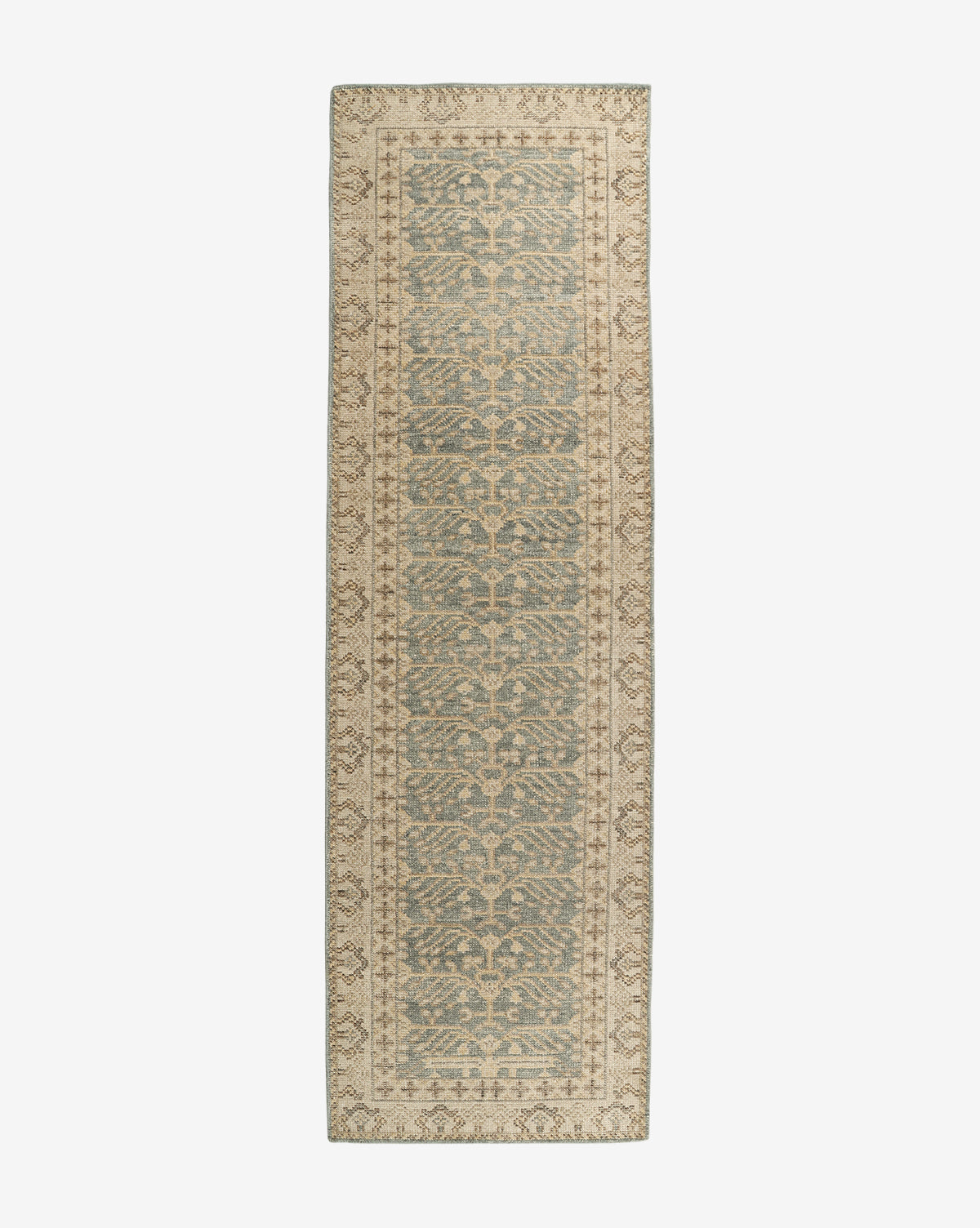 The Thames Hand-Knotted Rug is a long, narrow runner featuring a vintage, distressed look with muted blue and beige floral vines and a light beige border—perfect for adding an antique-inspired touch of luxury to any room, by McGee & Co.