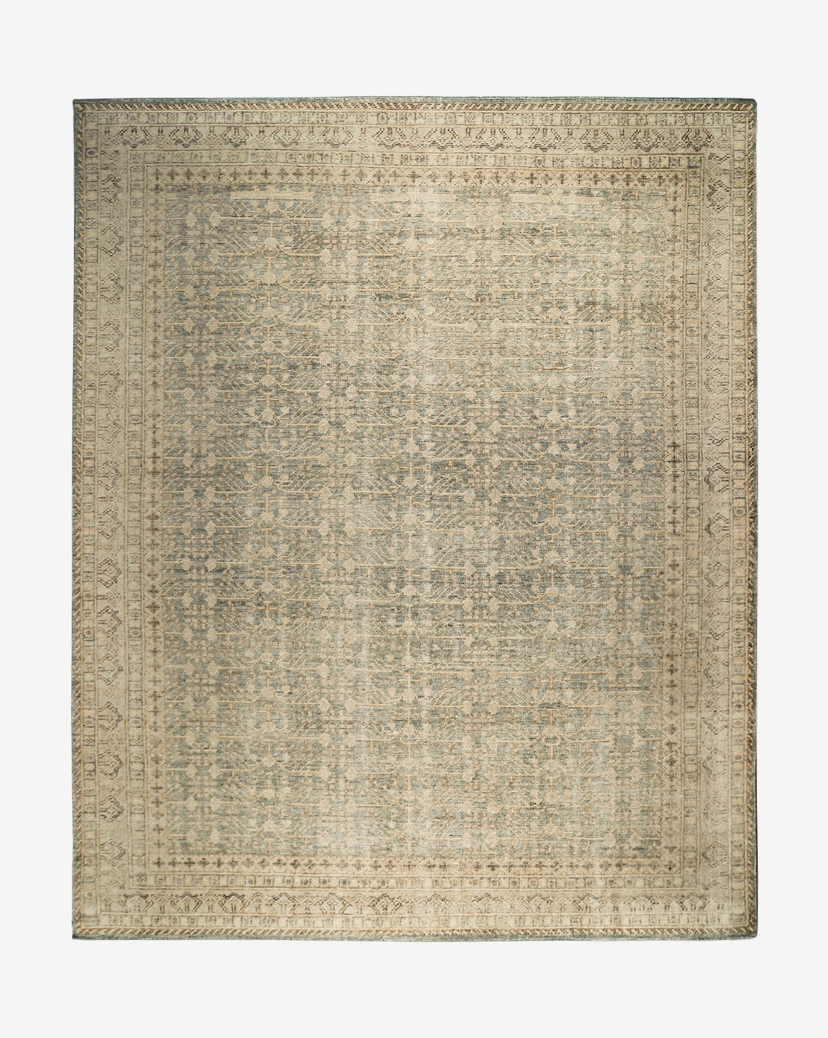 The Thames Hand-Knotted Rug features a rectangular, antique-inspired design with intricate faded patterns in beige, gray, and blue tones, a decorative border, and a vintage look—ideal for luxury home decor, by McGee & Co.