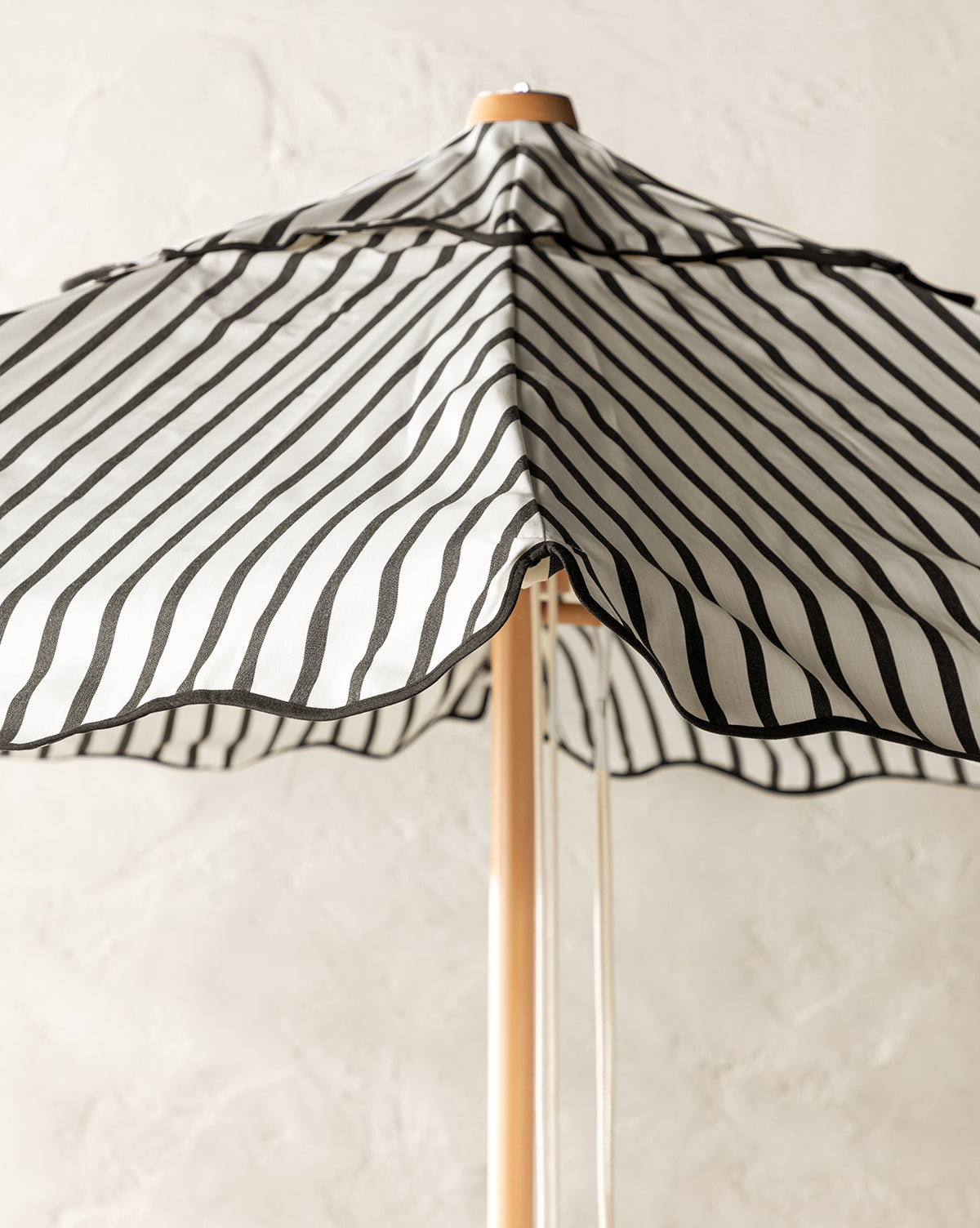 Black and white striped patio umbrella with bamboo base from McGee & Co.