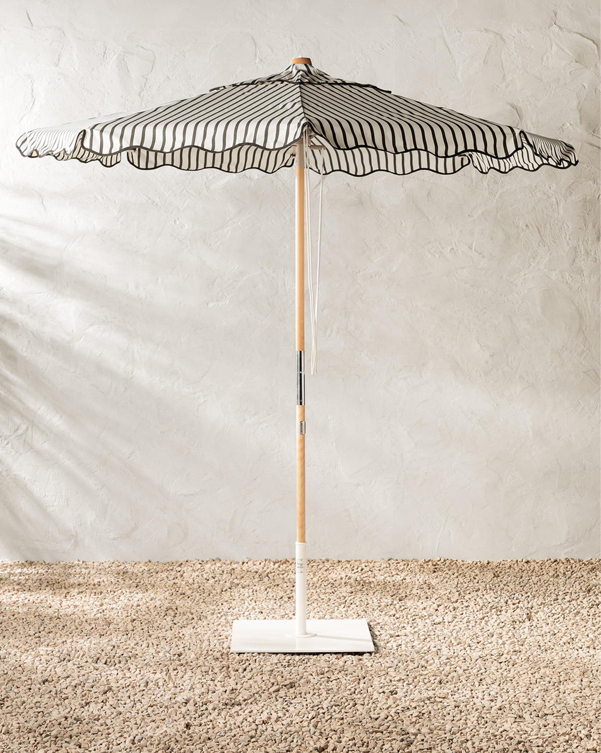The Market Umbrella in Monaco Black Stripe, can add a vintage feel our patio or poolside from McGee & Co.
