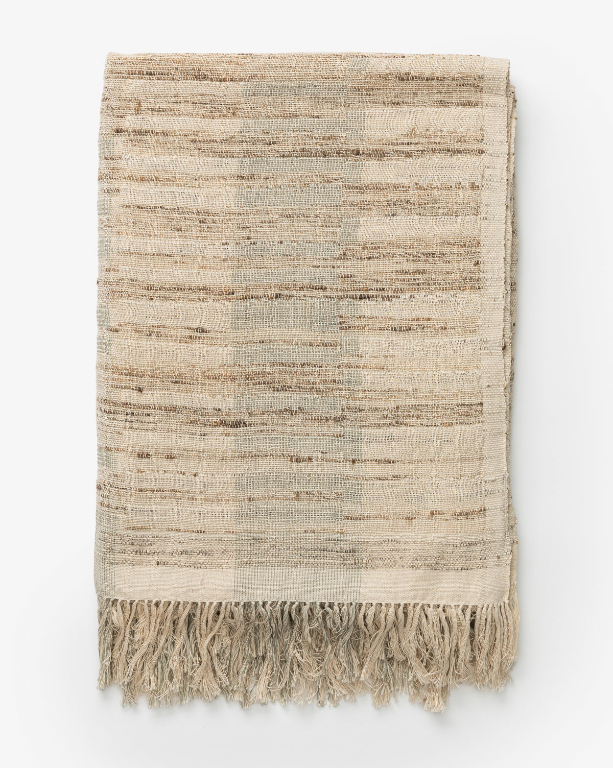 The Theodora Block Stripe Throw is a folded throw blanket in beige and light brown stripes with a subtle texture and fringed edges, displayed flat on a white background.