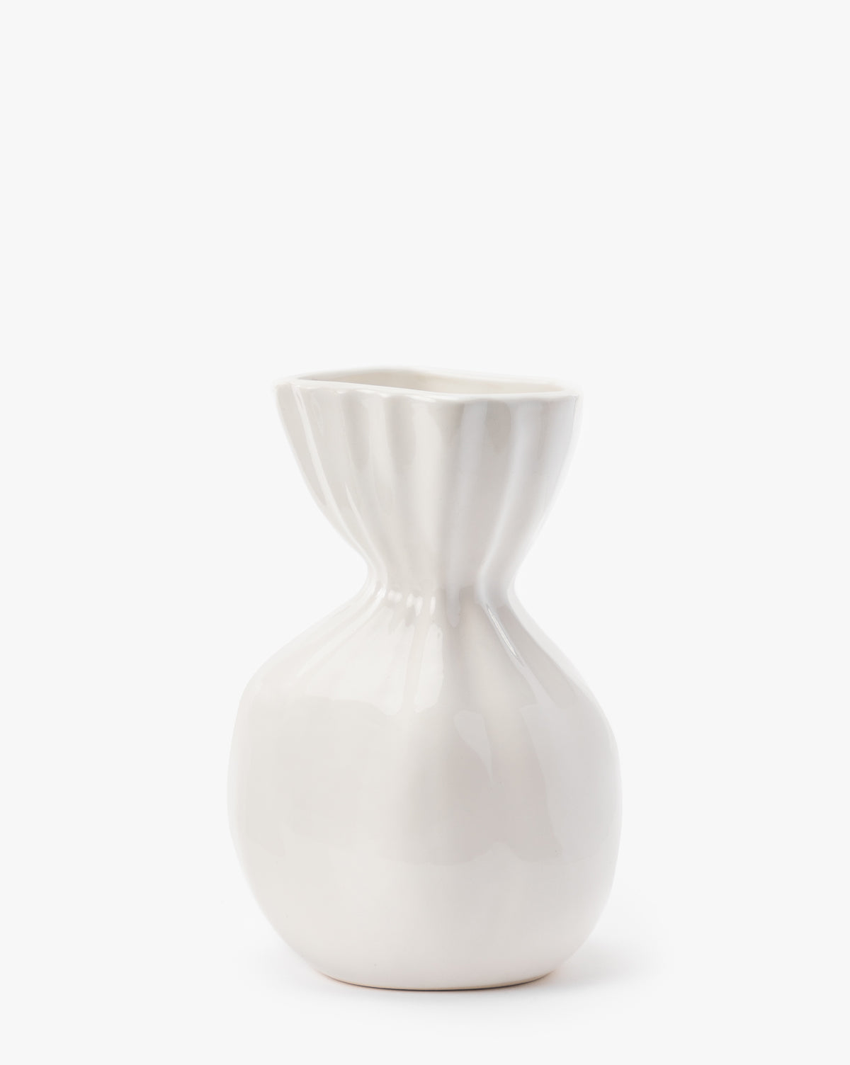The Thessaly Vase is a modern, glossy white ceramic vase with a rounded base and a narrow fluted neck that widens at the top, set against a plain white background.