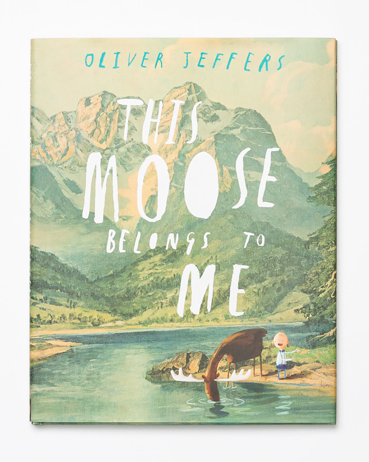 The cover of This Moose Belongs to Me shows a child and a brown moose by a lake, with mountains, trees, and the title in large white letters in the background.