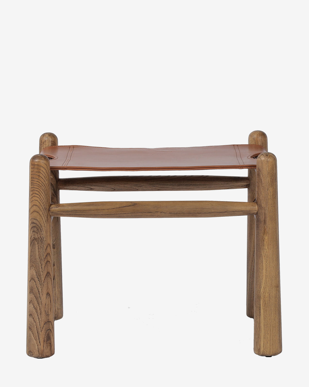 The Four Hands Tierney Ottoman features solid wood construction and a top grain leather seat, rounded legs, and simple, sturdy design, displayed against a plain white background. McGee & Co.