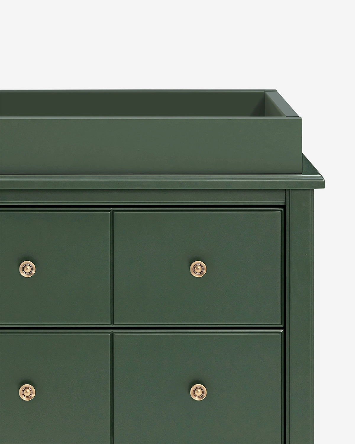 A close-up of the Universal Wide Removable Changing Tray in dark green with gold knobs, highlighting the top left corner and four drawers—ideal for organizing baby essentials against a plain white background, by McGee & Co.
