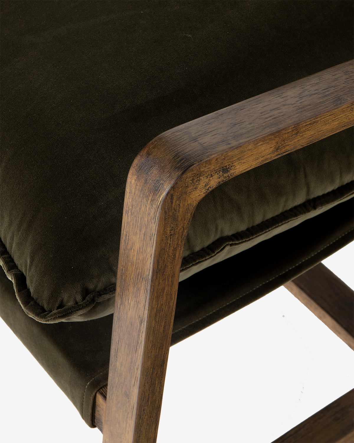 Close-up of the Ura Lounge Chair, showcasing its dark, high-performance fabric cushion and smooth solid ash frame, with a focus on the upholsterys texture and natural wood grain.