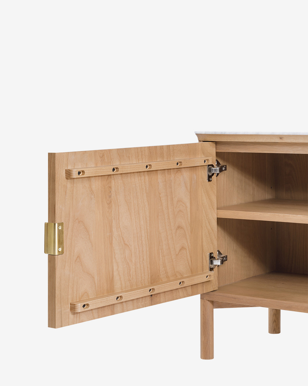 The Vale Sideboard features a light wood oak finish, a single door with antique brass hardware and a metal latch, revealing two interior shelves, by McGee & Co. It stands on four legs against a white background.