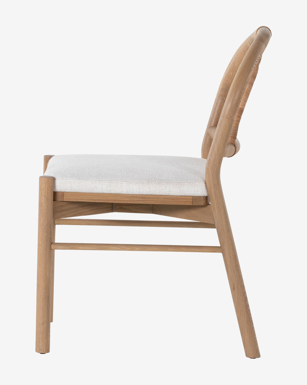 Side view of the Vasco Dining Chair featuring a light cushioned seat, curved backrest, and modern design, highlighting its sophisticated style as dining furniture against a plain white background by McGee & Co.