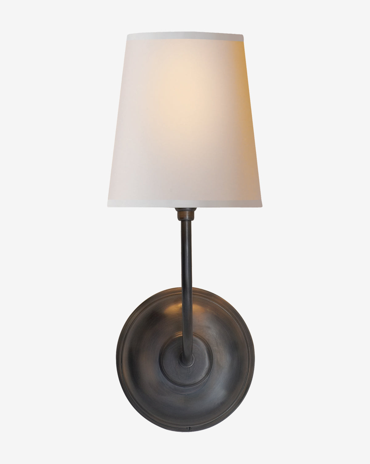 The Vendome Single Sconce by Visual Comfort & Co. Signature features a round dark metal base, straight vertical arm, and white linen shade—illuminated softly and ideal for use with a candelabra bulb. Available at McGee & Co.