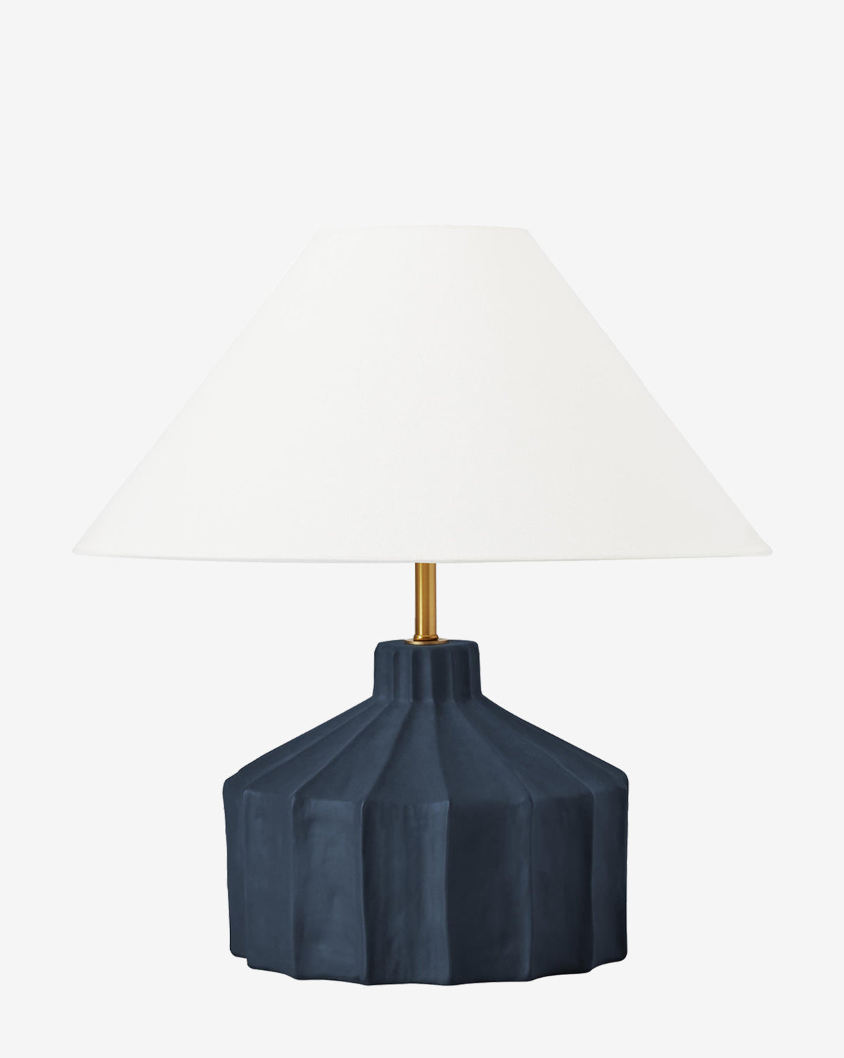 The Veneto Table Lamp has a geometric fluted base in dark blue ceramic and a wide white conical shade, bringing a modern touch to classic lamp design, by McGee & Co.