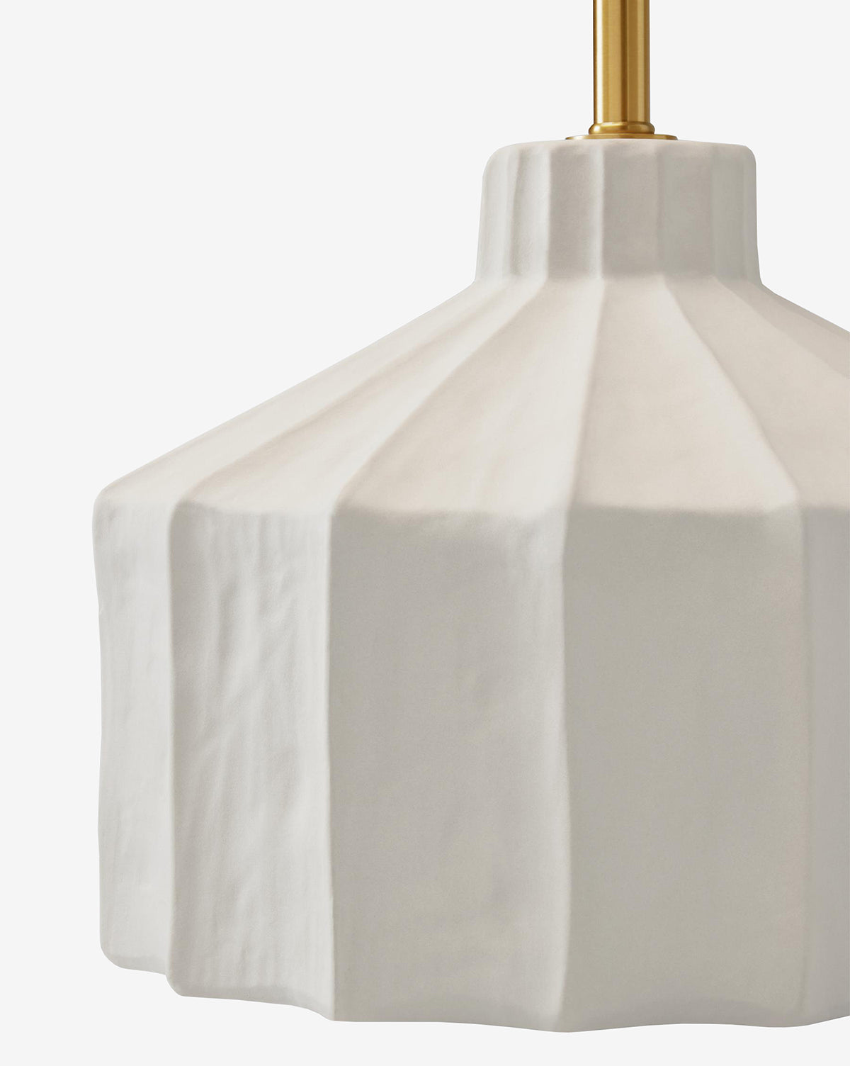 A close-up of the Veneto Table Lamp, featuring a matte white faceted ceramic shade and brass rod, blending modern style with traditional elegance, set against a plain white background, by McGee & Co.