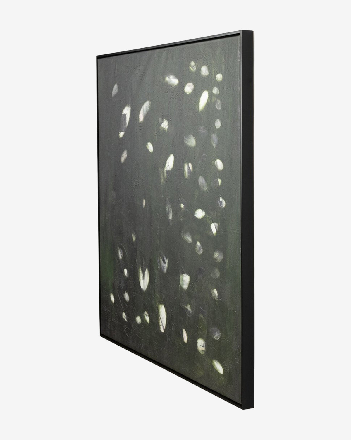 A side view of Verde Oculus by Jamie Beckwith, an abstract wall art with a dark background and scattered white and light gray ovals, framed in a sleek black maple floater frame for a modern, textured look.