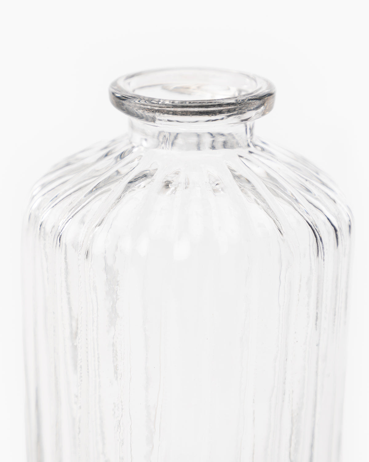 The Verlice Glass Cylinder Vase features vertical ribbed texture, round shoulders, and a short, wide neck. Photographed against a white background, its clear glass design complements various decor styles.