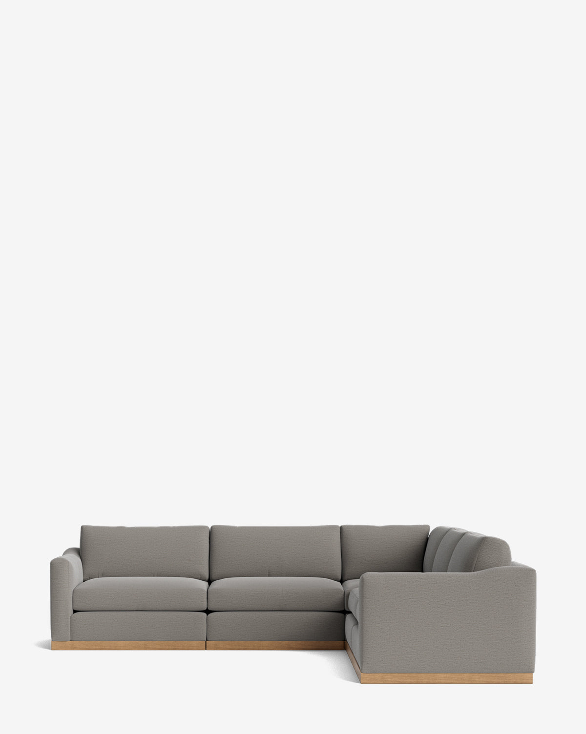 The Vernon Modular L Sectional 117.5 features gray velvet upholstery, plush cushions, and a light wooden base, shown against a plain white background by McGee & Co.