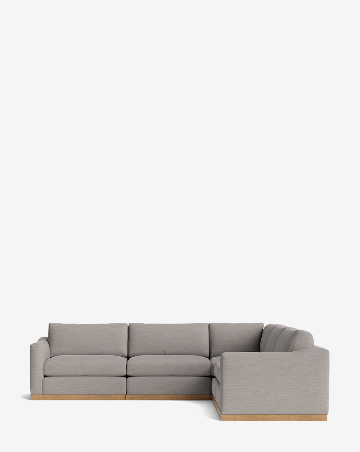 The Vernon Modular L Sectional 117.5 is a modern, light gray sofa with plush cushions and a wooden base, shown against a plain white background by McGee & Co.
