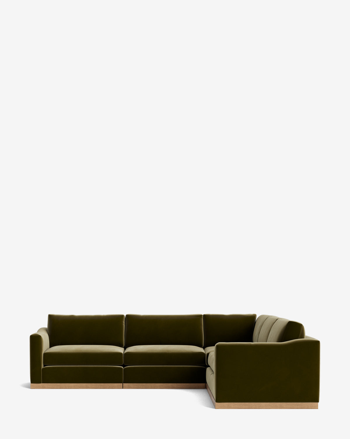 The Vernon Modular L Sectional 117.5 is a modern olive green velvet sofa with thick cushions and a low wood base, arranged in an L-shape against a plain white background by McGee & Co.