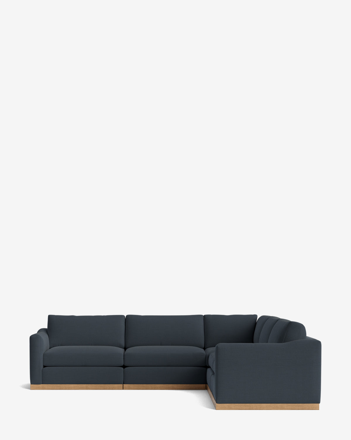 The Vernon Modular L Sectional 117.5 features dark blue upholstery and a light wood base, presented against a plain white background for a modern look, by McGee & Co.