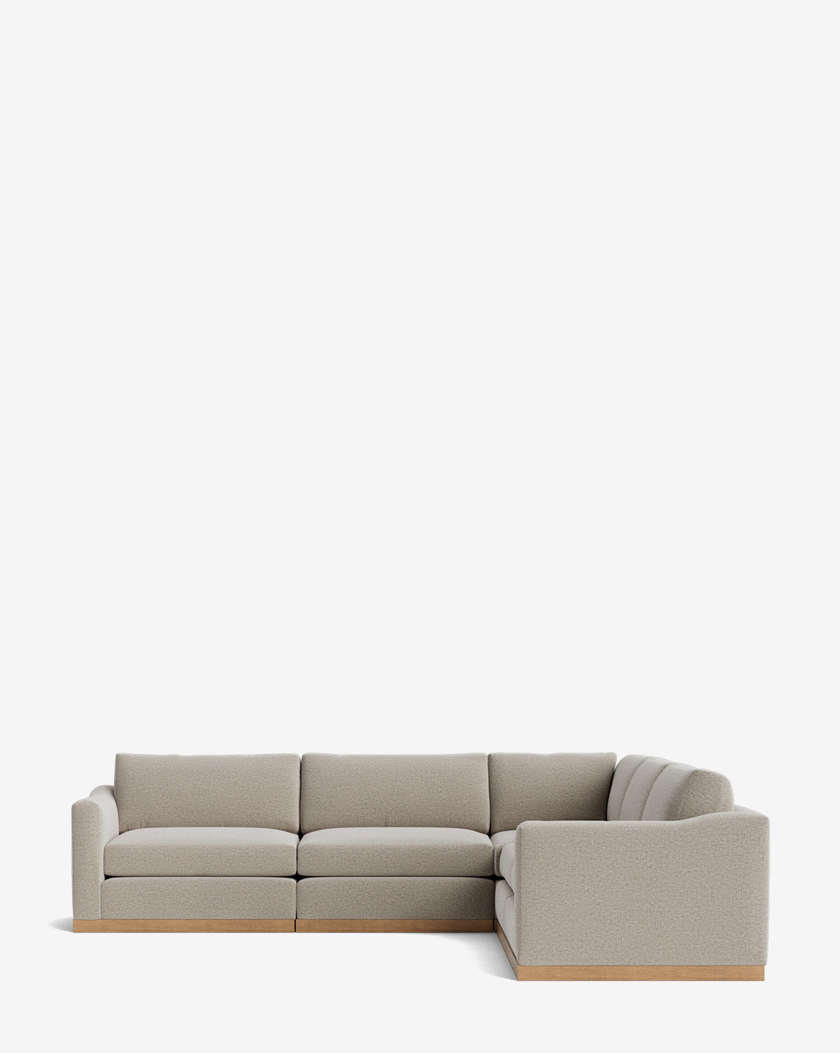 The Vernon Modular L Sectional 117.5 is a modern, light gray sectional with a low wooden base and thick padded cushions, shown against a plain white background by McGee & Co.