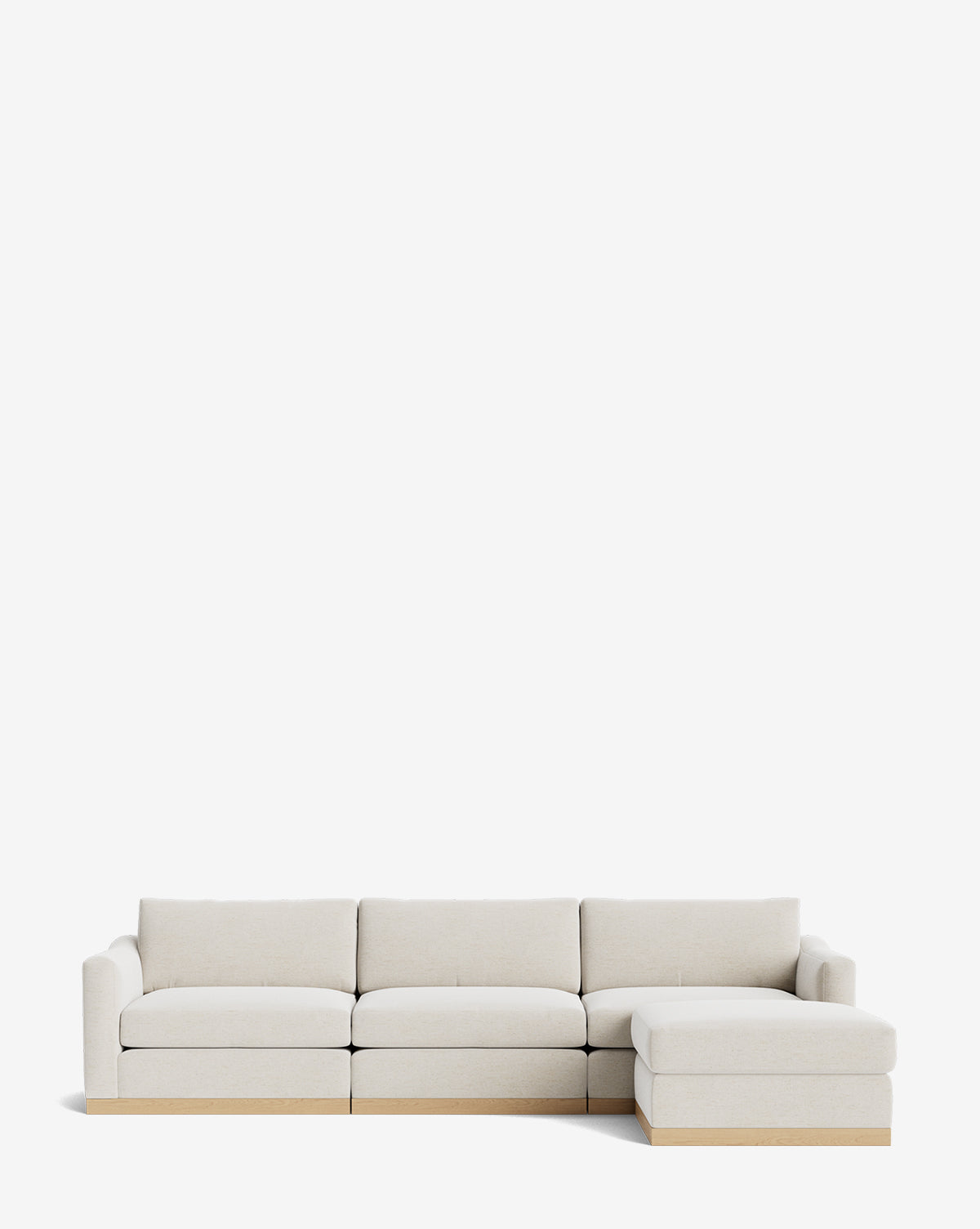 The Vernon Modular Sofa with Ottoman 121 is a modern, light beige fabric sofa with four seats, a right-side chaise lounge, minimalistic design, low wooden base, and plush cushions, shown against a plain white background by McGee & Co.