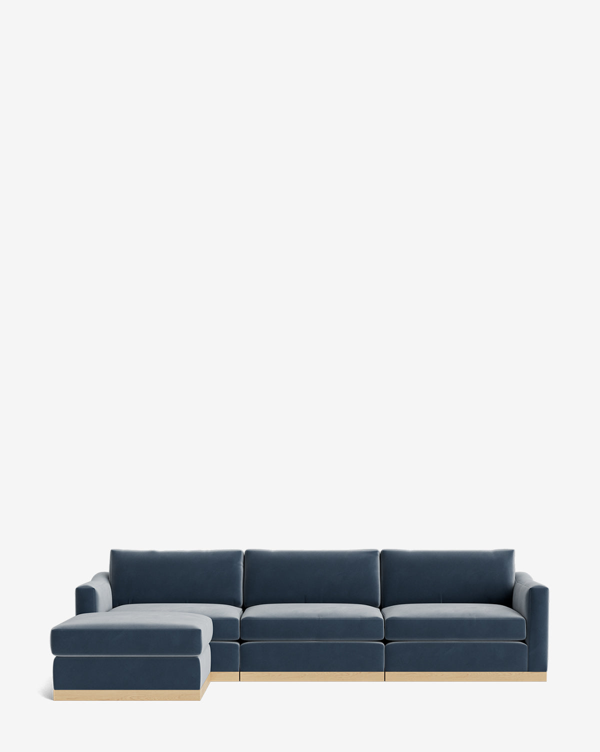 The Vernon Modular Sofa with Ottoman 121 is a modern sectional featuring dark blue upholstery, a wooden base, and a left-side chaise lounge. Shown on a plain white background, this customizable fabric sofa offers style and comfort for any living space by McGee & Co.
