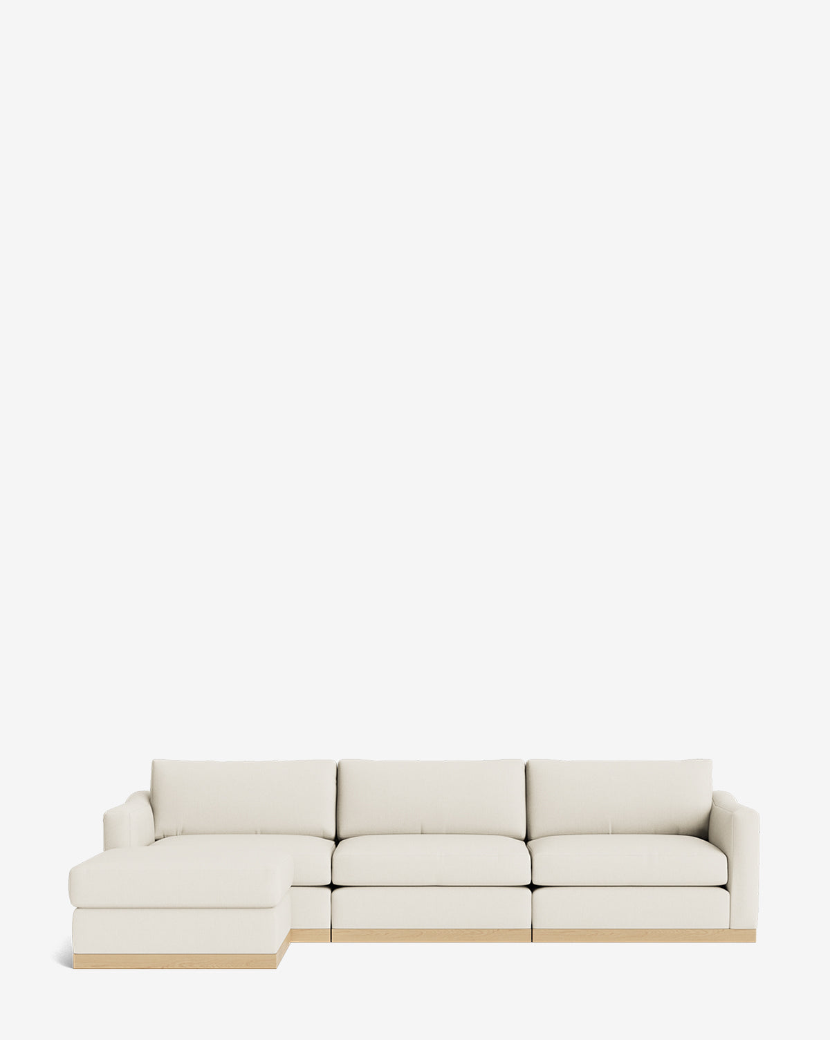 The Vernon Modular Sofa with Ottoman 121 in light beige features a left-facing chaise and wooden base, by McGee & Co. This customizable fabric sofa is showcased against a plain white background.