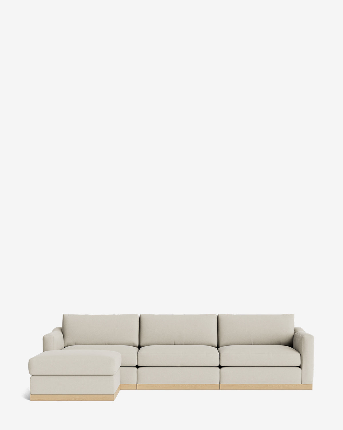 The Vernon Modular Sofa with Ottoman 121 is a modern beige sectional featuring plush cushions, a light wooden base, and a left-side chaise. This customizable fabric sofa is shown against a plain white background by McGee & Co.