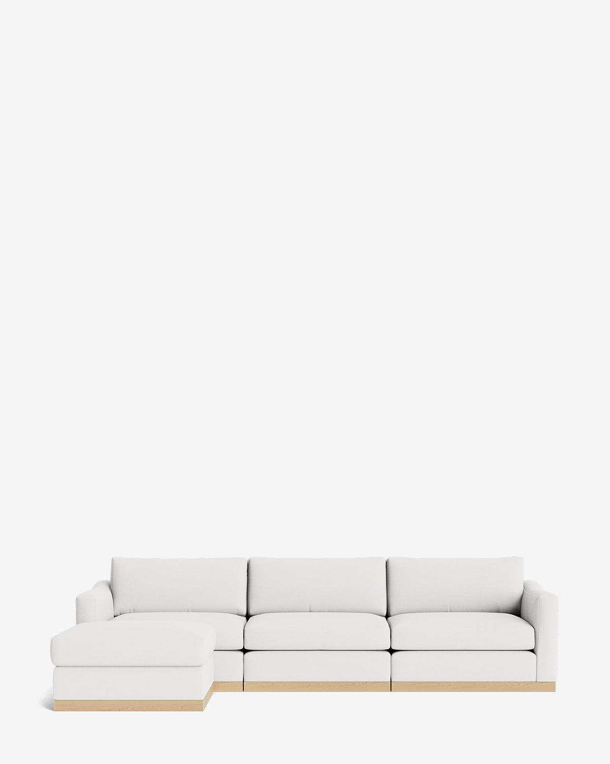 The Vernon Modular Sofa with Ottoman 121 is a modern white sectional featuring a left-side chaise, wooden bases, and clean lines, by McGee & Co. This customizable fabric sofa is shown against a plain white background.