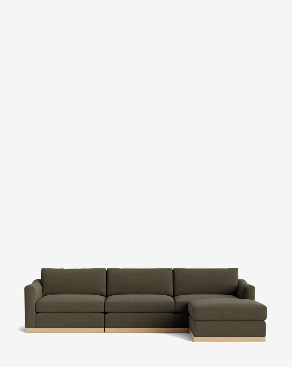 A modern Vernon Modular Sofa with Ottoman 121 features dark green upholstery, three seat cushions, a right-side chaise, a light wood base, and is shown against a plain white background by McGee & Co.