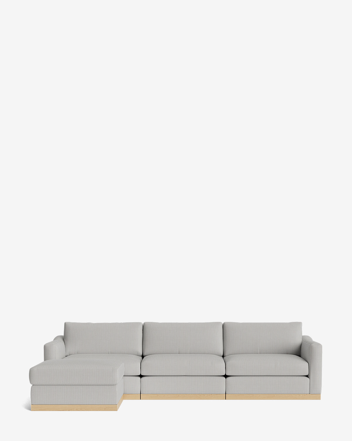The Vernon Modular Sofa with Ottoman 121 is a modern, light gray sectional featuring a left chaise and light wooden base, by McGee & Co. This customizable fabric sofa offers style and comfort for any living space, shown here against a white background.