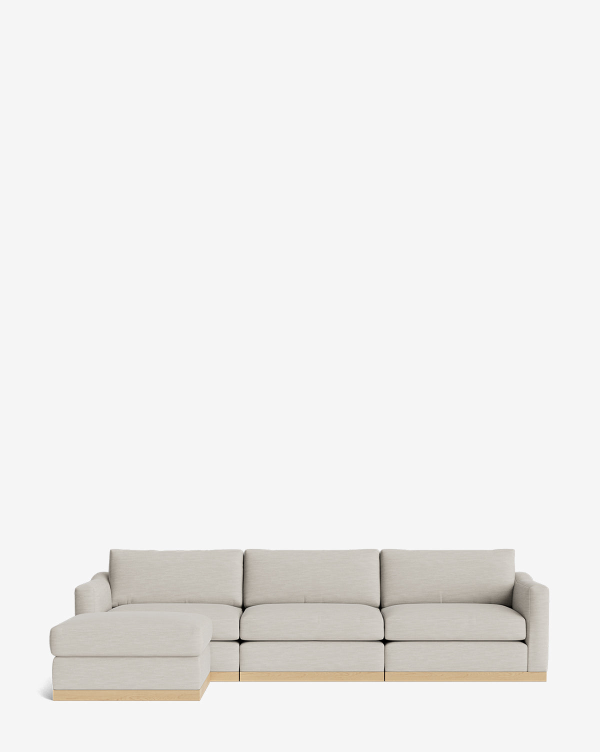 The Vernon Modular Sofa with Ottoman 121 in light gray features four seat cushions, a left-side chaise lounge, and a low wooden base, by McGee & Co. This customizable fabric sofa blends comfort with contemporary style against a plain white background.