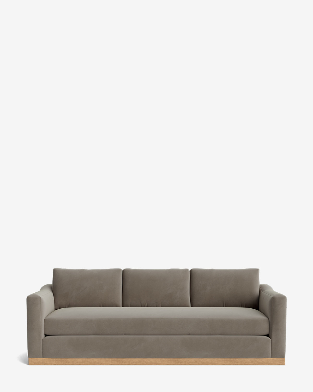 The Vernon Sofa 92 is a modern, three-seat velvet sofa with gray upholstery, square arms, three back cushions, and an alder wood frame with a light wooden base, shown on a plain white background by McGee & Co.