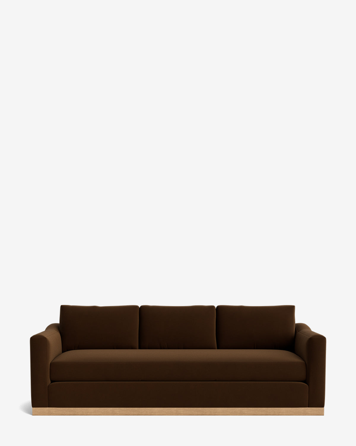 The Vernon Sofa 92 is a brown velvet three-seater with three back cushions and wide armrests, featuring an elegant alder wood frame, shown against a plain white background by McGee & Co.