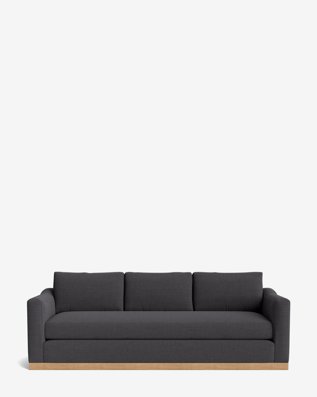 The Vernon Sofa 92 is a modern dark gray velvet sofa featuring three seat and back cushions, low arms, and an alder wood frame base, shown against a plain white background by McGee & Co.