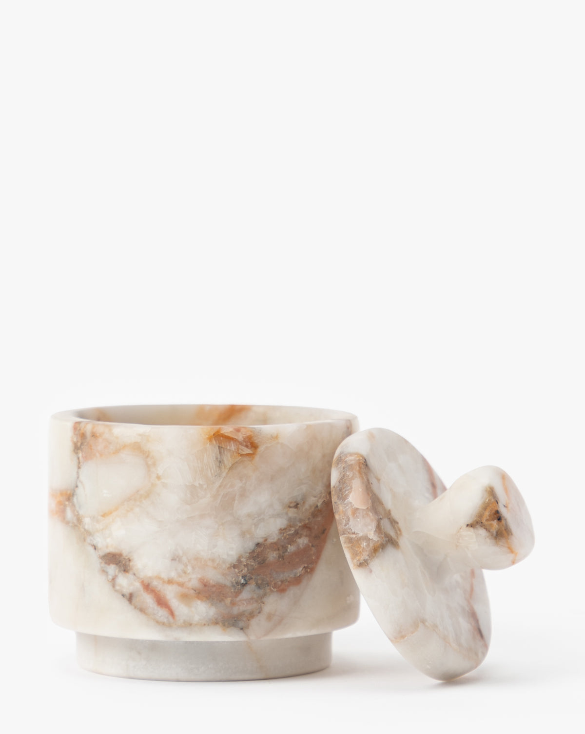 The Verona Matte Marble Lidded Jar showcases natural beige and brown veining, with its matching lid resting beside it on a white background—an elegant choice for stylish kitchen countertop decor, by McGee & Co.