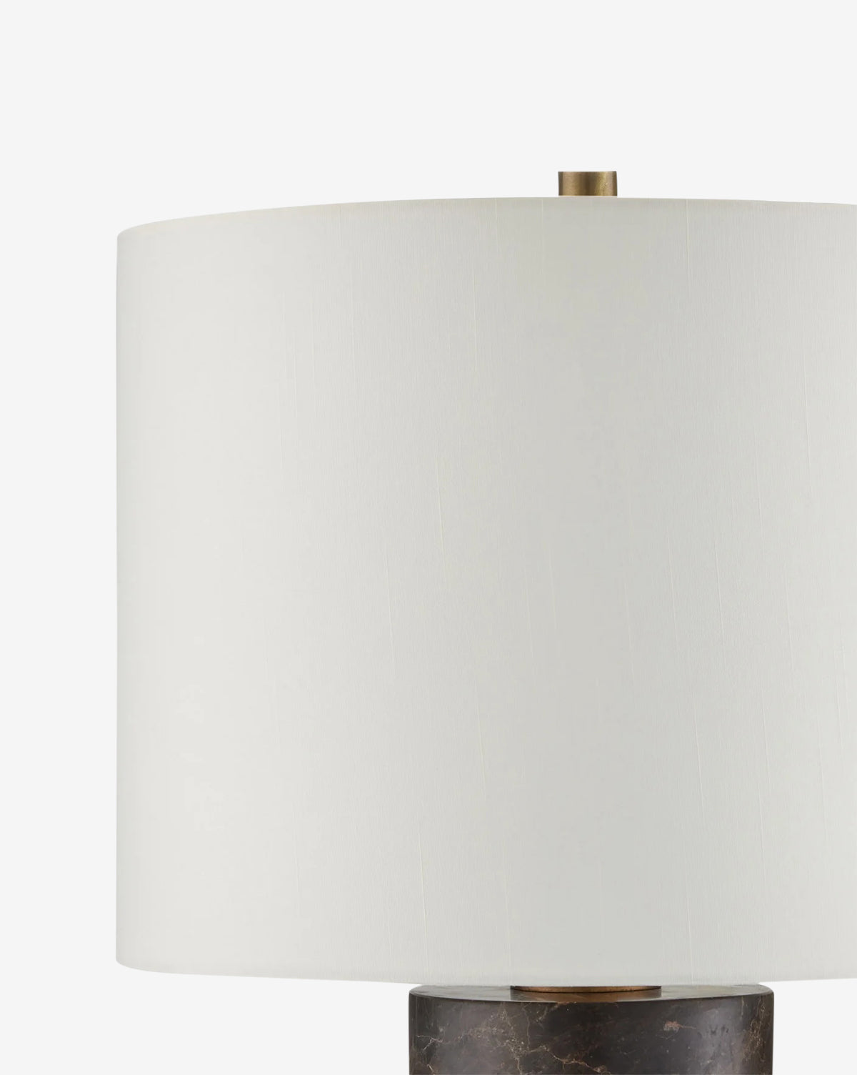 A close-up of the Vespera Table Lamp, showcasing its white cylindrical shade, antique brass accents, and dark marble column base against a plain white background, by McGee & Co.