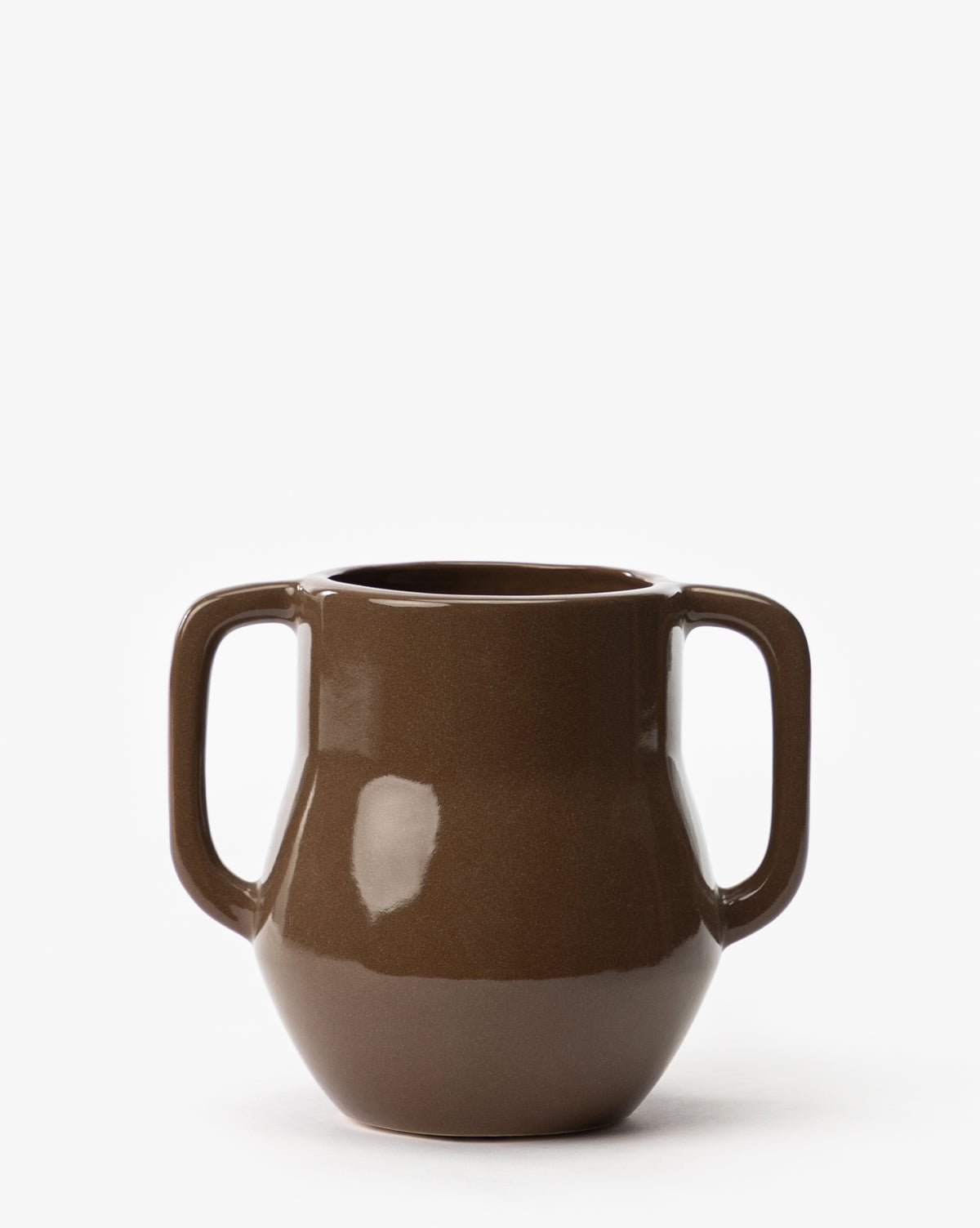 The Victoire Vase is a brown ceramic piece with a glossy finish, featuring two large handles on opposite sides, and is displayed against a plain white background, by McGee & Co.